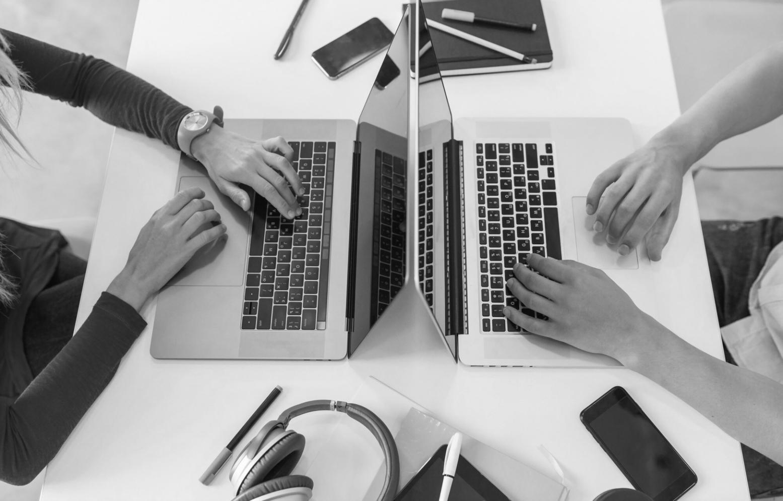 Student working on laptop with financial planning documents and calculator